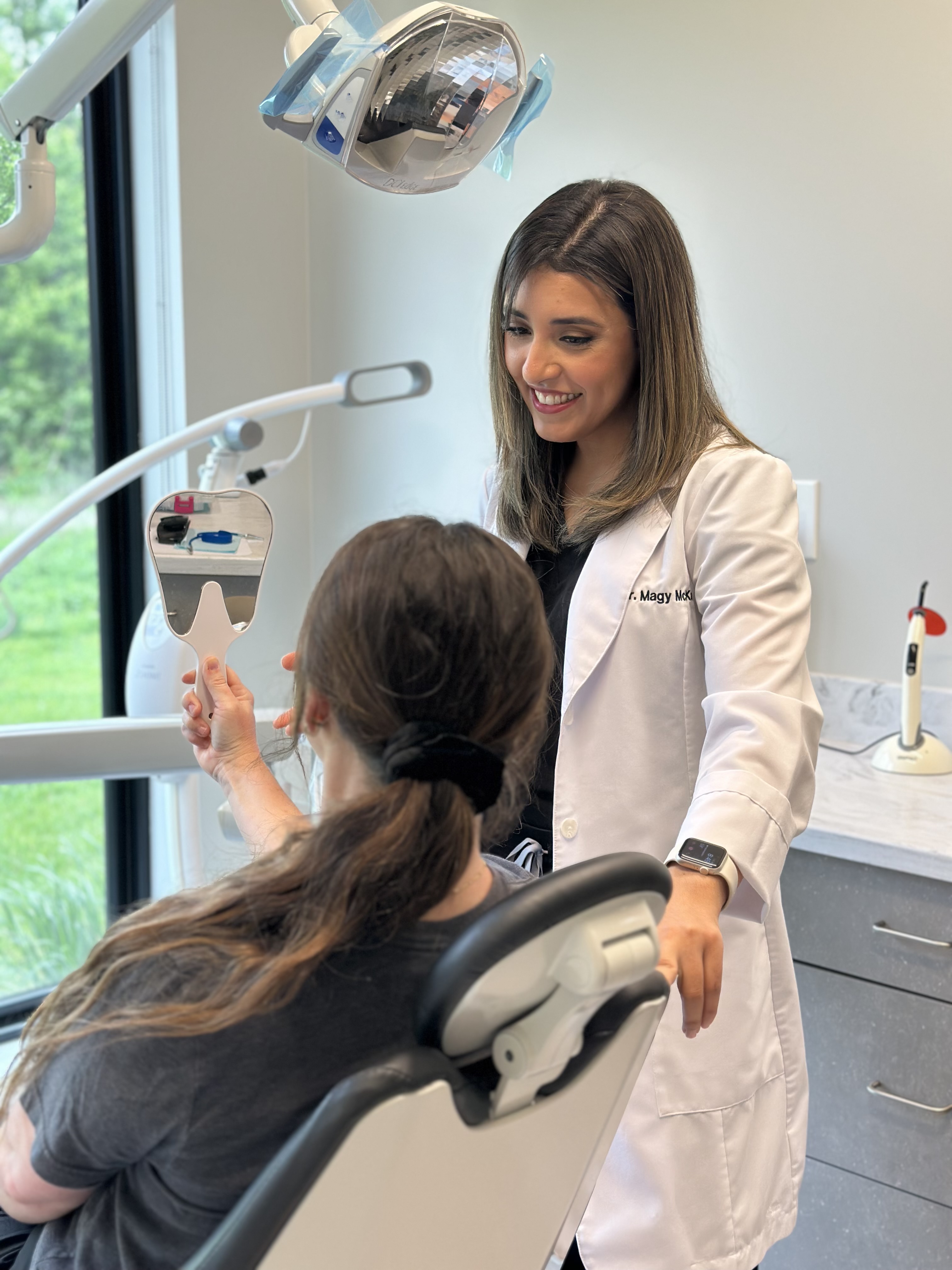 Dr. Magy McKary showing a patient her new smile in the chair at McKary Family Dentistry